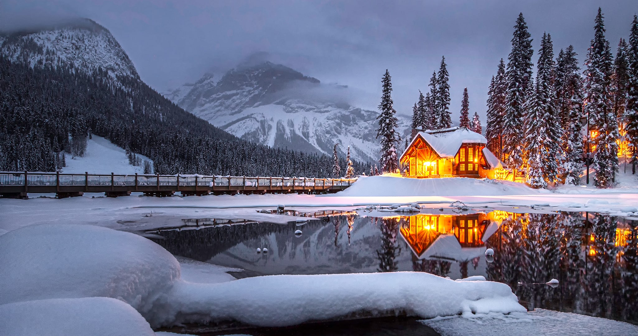 Snowy home near a lake.